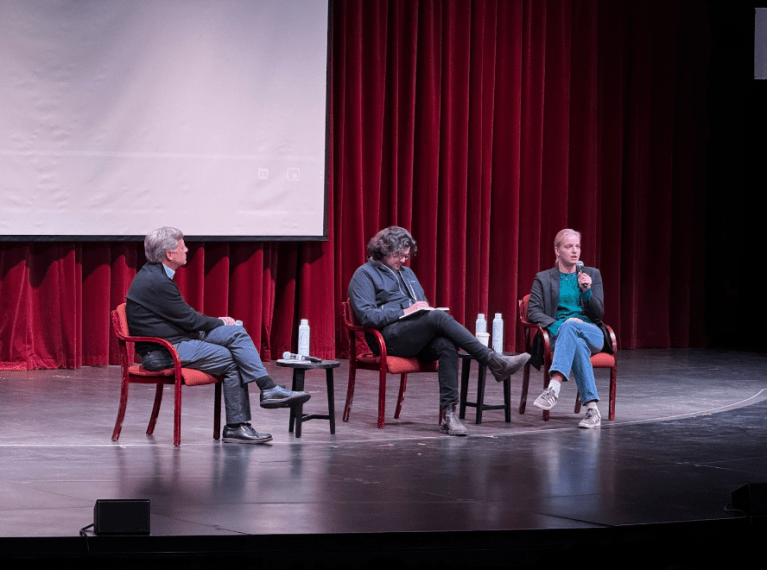 From left to right, former ambassador to Russia Michael McFaul, filmmaker Daniel Roher, and Dasha Navalnaya ’24 sitting on a stage discussing a screening of Navalny.